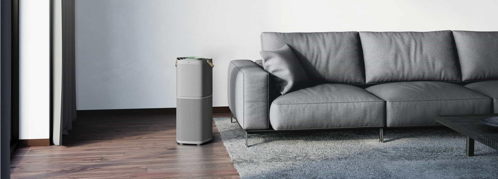 An Air purifier next to a couch 