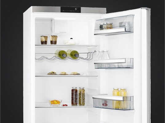 freestanding refrigerator with open door displaying wine &  food being cooled